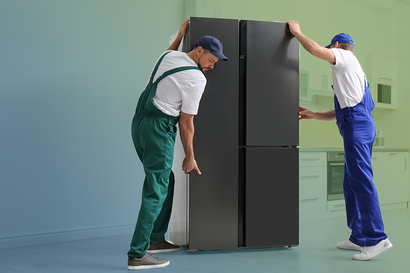Two movers removing a refrigerator Two movers removing a refrigerator