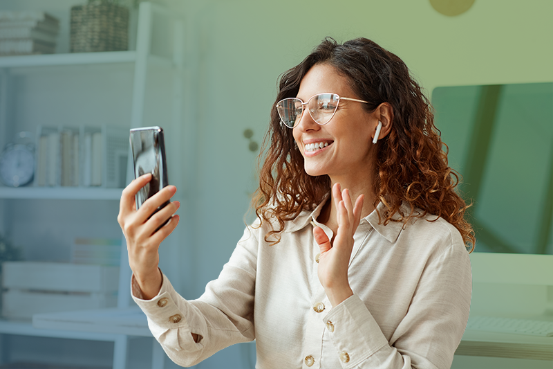 woman is having a video call on her smartphone in her home woman is having a video call on her smartphone in her home